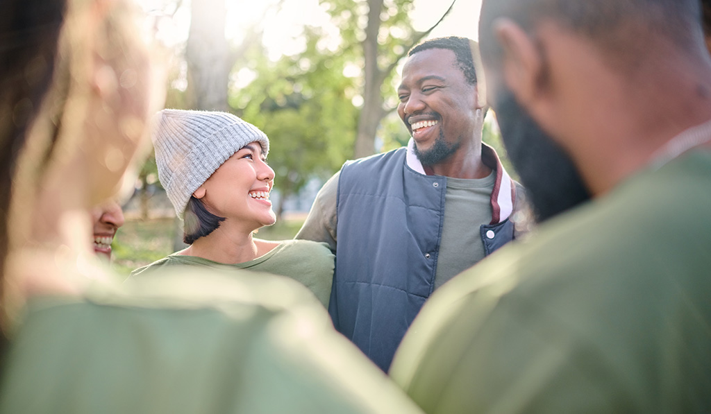 Diverse group of people laughing and connecting outdoors in a park