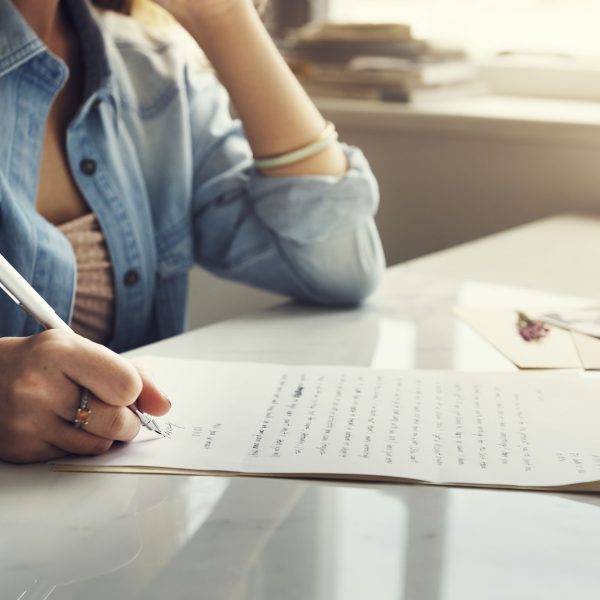 Caucasian woman writing a letter
